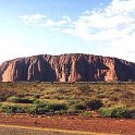AUS NT AyersRock 2001JUL12 001  About 450 kilometers (280 miles) to the southwest of Alice Springs you'll find Ayers Rock, the world's biggest monolith. To the locals it's known as simply "The Rock". : 2001, 2001 The "Gruesome Twosome" Australian Tour, Australia, Ayers Rock, Date, July, Month, NT, Places, Trips, Year